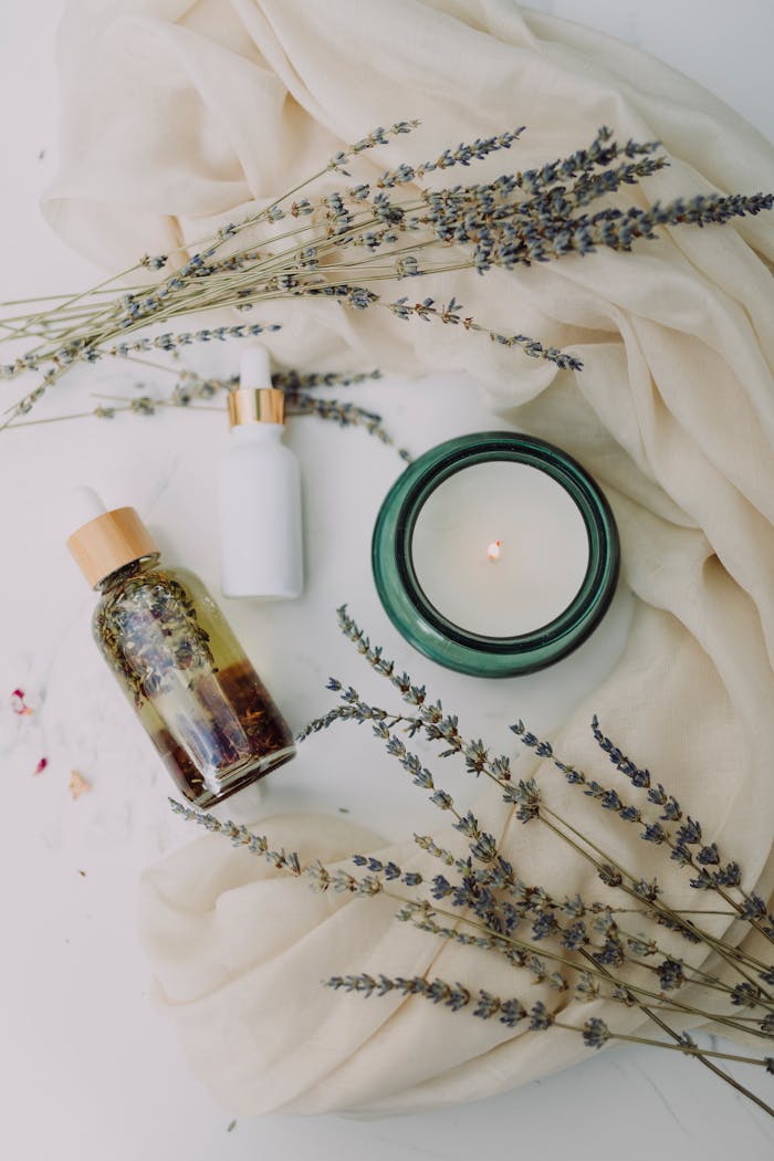 A calming flat lay of spa essentials featuring lavender and candles for relaxation.